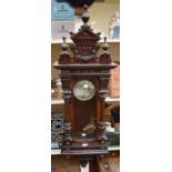 A large 19th century mahogany German 8-day wall clock with Arabic numerals, in a silvered and