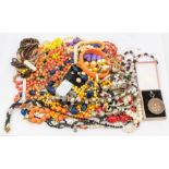 A collection of costume jewellery to include plastic bead necklaces, faux pearls, brooches,