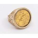 A 9ct gold mounted ring inset with a George V sovereign dated 1911, foliate decoration to mount,