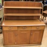 A mid-20th century Ercol style dining room set, i.e. drop leaf table badly damaged surface), four