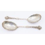 A pair of Victorian silver serving spoons with twisted stem, mask and berry ornamentation to the