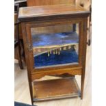 An Edwardian mahogany glazed display cabinet with a blue velvet shelf