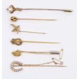 A collection of late Victorian early 20th century stick pins, including pearl set lyre 15ct gold,