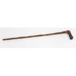 An English carved walking stick, reticulated handle, above tapering stick carved with oak leaves,