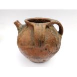 A large and impressive medieval earthenware three-handled vessel with pouring spout, c. 1500. It has