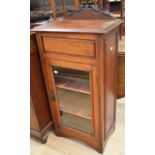 An Edwardian mahogany single door lift top book case, carved crest rail, above glazed door, two