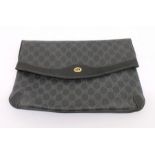 A black coated canvas Gucci bag patterned with the GG logo. On the front it has the GG gold metal