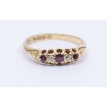 A Edwardian ruby and diamond set 18ct gold boat head ring, comprising three graduated round cut