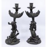 A pair of French bronze candlesticks, cast as Putti riding dolphins, shell bases, approx 27.5cm