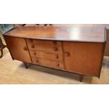 1970s Hunters of Derby teak sideboard with four central drawers flanked by cupboard doors,