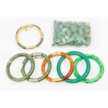 A collection of round section bangles to include two nephrite type jade, agate and hematite both