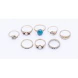 A collection of eight 9ct gold gem set rings to include two opal and garnet three stone rings, sizes