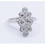 An Art Deco diamond and platinum ring, comprising a tiered design set with graduated diamonds, total