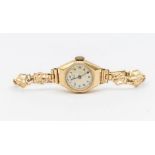 A ladies 9ct gold vintage Avia wristwatch, round champagne dial with Arabic number markers, case