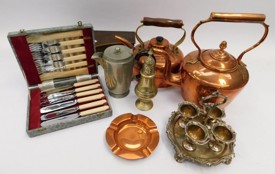 A collection of copper and silver plated items, including silver napkin rings and piano music