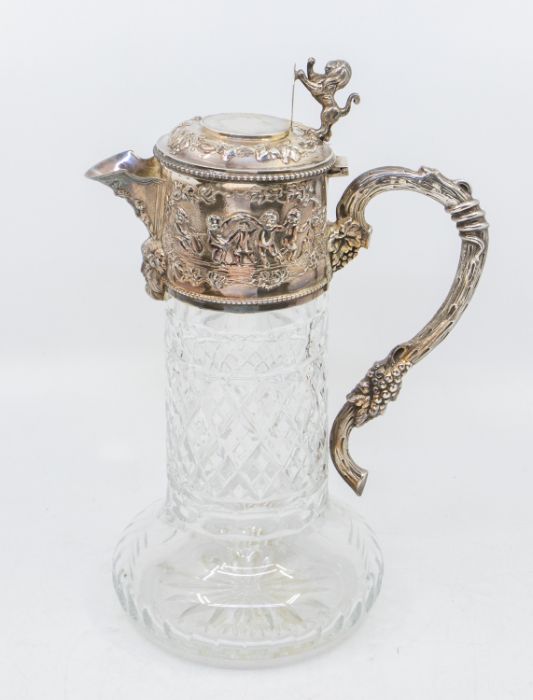 A Victorian style silver and cut glass claret jug, with silver collar, lid and handle, decorated