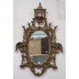 An 18th Century style gilt mirror, wooden in construction, with Eastern style building, of bolsa