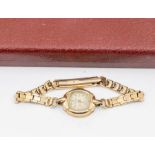 A ladies 9ct gold vintage Rotary wristwatch, textured dial with applied arrow and number markers,