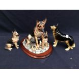 A Border Fine Art large model of a German Shepherd and two puppies, on stand together with two