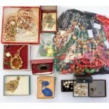 A collection of costume jewellery to include vintage glass bead necklaces, china brooches, faux