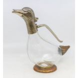 A novelty glass and plate mounted claret jug in the form of a duck, with a glass body. (wearing to