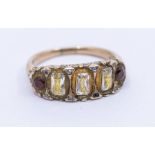 A garnet and cubic zirconia gold dress ring, scrolled mount, unmarked assessed as 15ct, size Q,