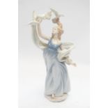A large Lladro figure of a girl with doves - 38cm high