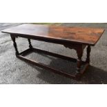 A Charles I oak refectory table, circa 1630, two plank top, raised on baluster on block supports