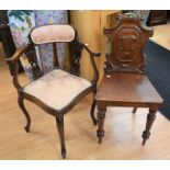 A mid 19th century oak hall chair with shield back detail, together with an Edwardian mahogany