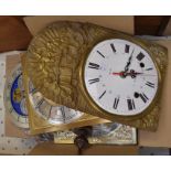 A collection of wall clock workings and clock faces, including French