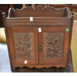 A late 19th century oak table-top smokers cabinet with carved front doors