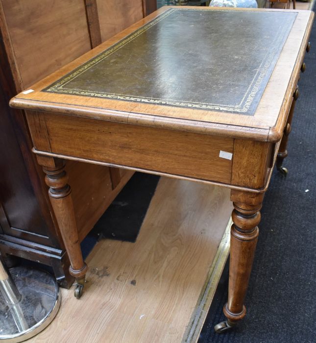 An early 20th century light oak olive green tooled leather topped office desk with four turned - Image 3 of 3