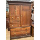 A late 19th century solid oak housekeeper's cupboard with 20th century brass handles, seven