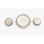 A Victorian mourning brooch, circular form, engraved to the centre with foliate decoration, beaded