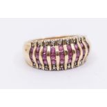 A ruby and diamond 9ct gold ring, comprising central vertical rows of round cut rubies, channel set,