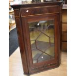 A George III mahogany glazed corner cupboard with small single drawer in base