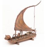 A bronzed Chinese model of a fishing boat, present to Ray Griffin General Motors for help in