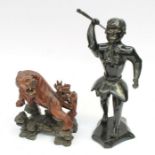 An ebonised wooden figure of an African tribal member holding staff and on ebonised base, (has
