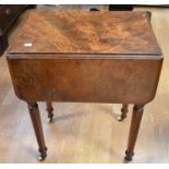 A 19th century walnut sewing/work table with drop-leaf sides, two side drawers and dummy cupboard