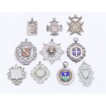 A collection of six silver fob medallions, various shapes and designs, to include four with enamel