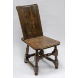 A mid-17th century oak stool, turned legs and detachable back rest, pegged joints, scrolled top