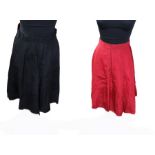 A late 1950s reversible (red taffeta/black) skater skirt, size 6/8, with a 4-button front fastening;