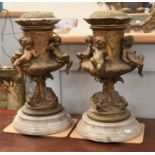 A pair of 19th Century candle holders which have been converted into lamp bases, on marble stands