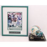 American Football: A framed and glazed photograph, signed by Dan Marino, signature faded; together