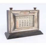 A George V silver mounted desk calendar with ebonised back and stand, hallmarked Birmingham 1932,