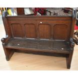 A late 19th century oak small church pew