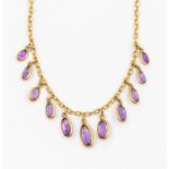 An early 20th century amethyst and gold fringe style necklace, comprising fine chain suspending a