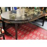 An early 20th century Japanese two leaf dining table, black lacquered oval ends with gilt cherry