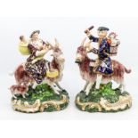 A pair of 19th Century Bloor Derby figures of the Welch Tailor and his Wife, both astride goats, she