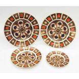 Four Royal Crown Derby 1128 Imari pattern plates: two large, second quality; one medium and one